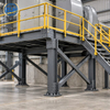 Industrial steel support structure integrated with an access platform and stairs