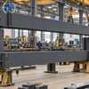 Workers conducting trial fit-up of prefabricated industrial steel frame sections